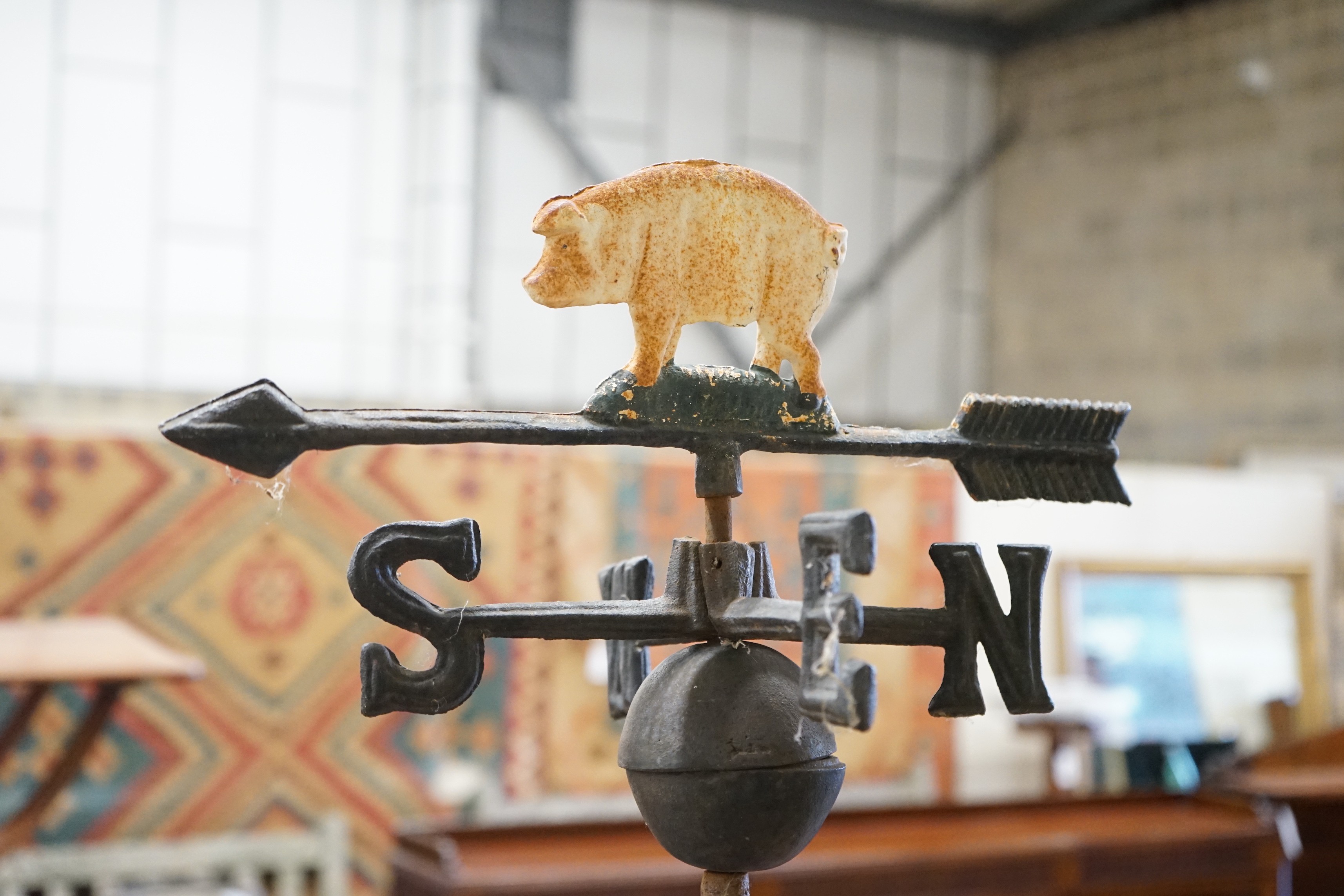 A painted metal pig weather vane on associated stand, height 76cm